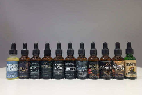 Beard oil bottles lined up together with dropper tops