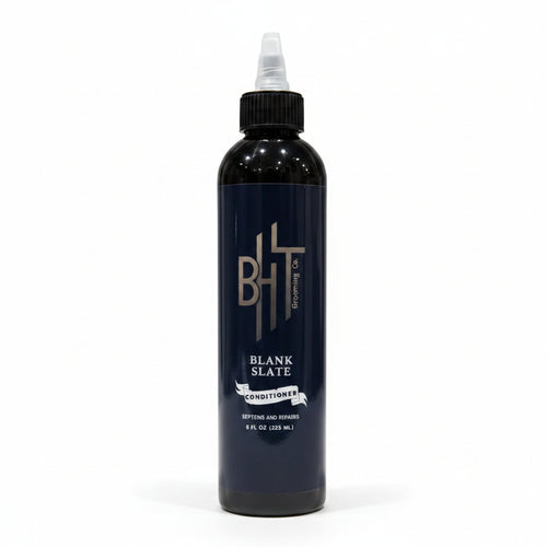 Black bottle with a label on a gray background